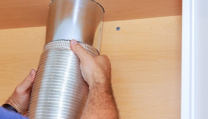 Serv_Range-Hood-Problems_3.jpg A service technician removed the hood filters to peer inside