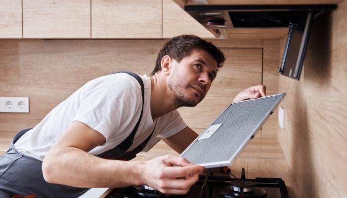 Serv_Range-Hood-Problems_3.jpg A service technician removed the hood filters to peer inside