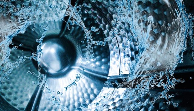 View of water splashing around inside a washer drum