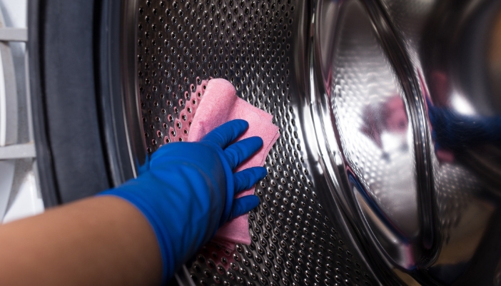 Closeup of someone cleaning their washer drum