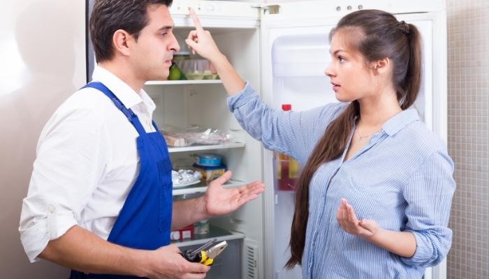 Woman explaining problem to service repairman
