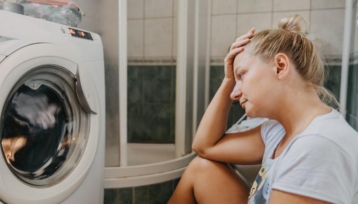 Woman upset by noise the washer makes