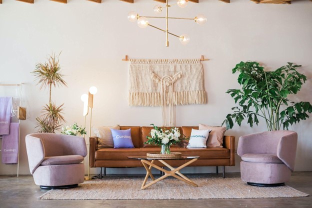 Lilac colored accent chairs are featured in a boho inspired living room