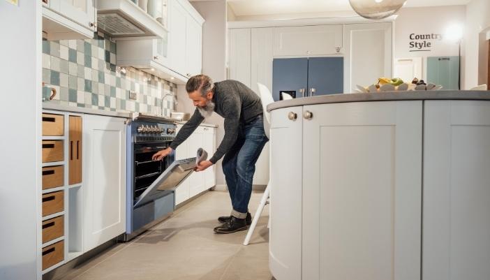 Man is reaching for something in his bran-new range