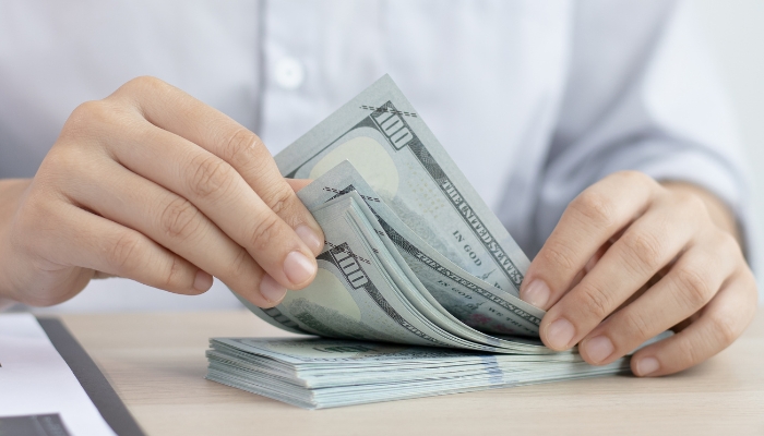 Closeup of person counting their savings