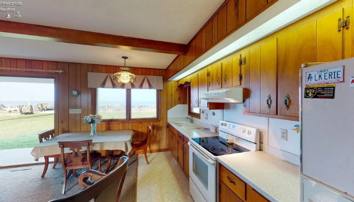 lakeside home with dated kitchen cupboards and appliances