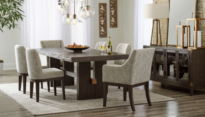 A neutral colored dining room with six chairs and golden accents.