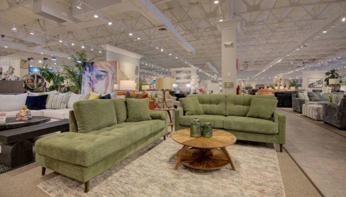 An image of a furniture showroom focusing on a green living room set.