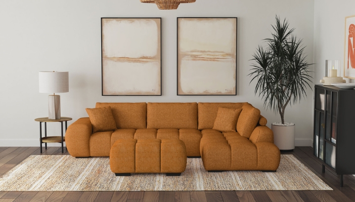 An L-shaped burnt orange couch with neutral decor accents.