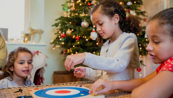 A family playing a board game at the holidays.