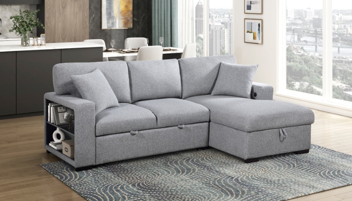 A gray couch in a modern living room that opens on one end with storage.