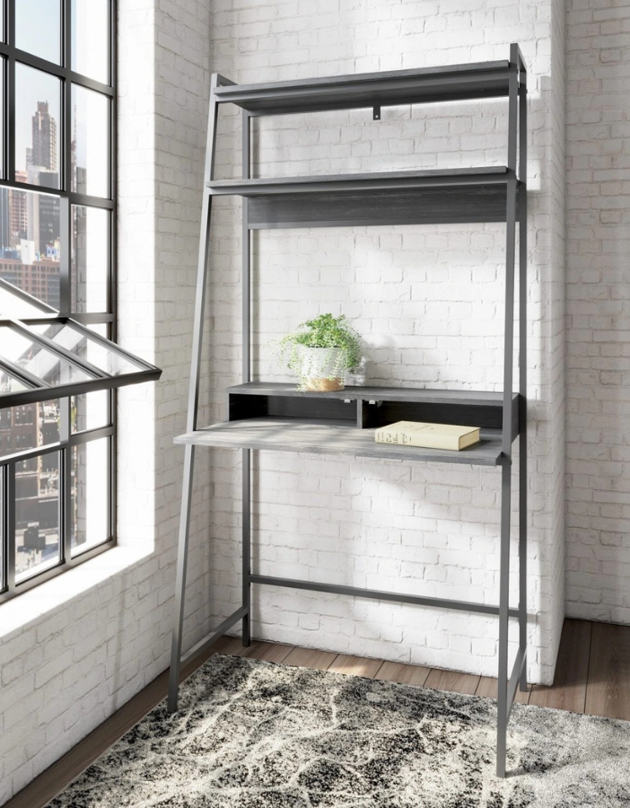 A black desk with black shelving units above it in a modern living room. 