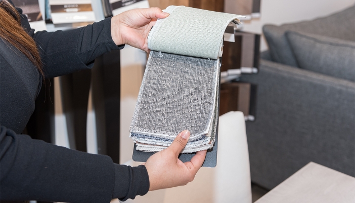 woman holding fabric swatches