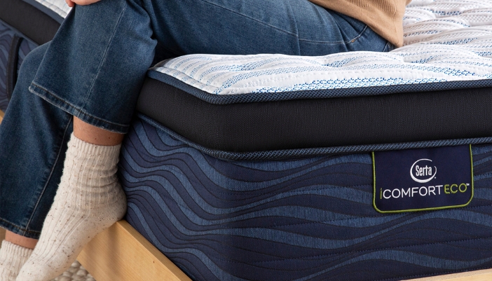 person sitting on serta mattress
