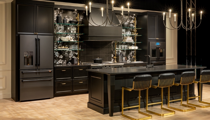 A modern kitchen with all black appliances and black cabinets/metalwork. 