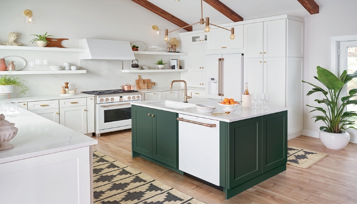 A modern brighly lit kitchen with white appliances and woodwork.