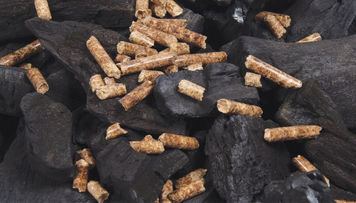 A combination of charcoal and wood pellets on a grill. 