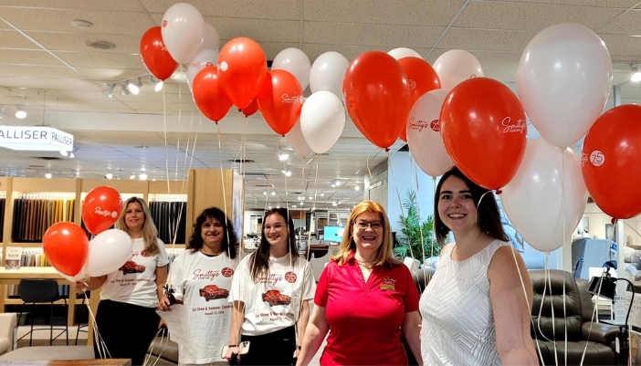 Smitty's employees celebrating the current furniture sale.