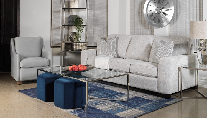 A modern living room with gray furniture and blue accents.