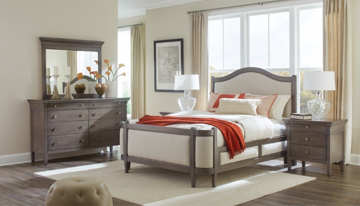 A modern bedroom set in dark gray with white bedding and a red accent.