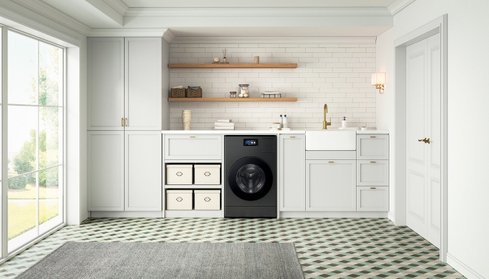 A combo washer/dryer sits in a modern white laundry room.