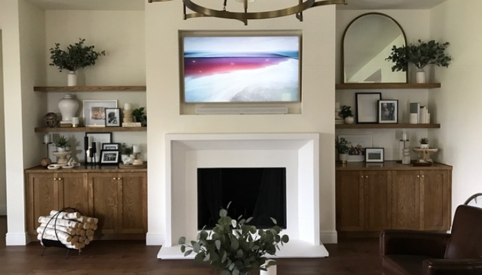 A modern living room with a flatscreen TV on the wall.