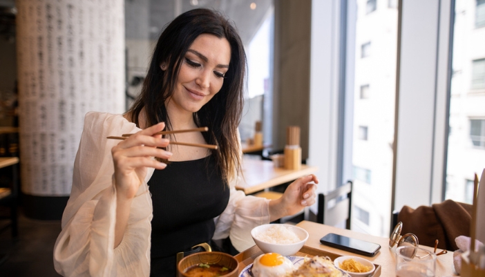 Woman enjoying her food at a restaurant