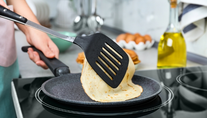Closeup of someone cooking on an induction stove