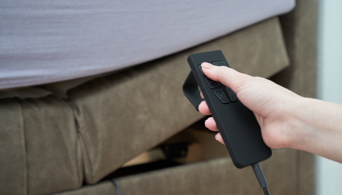 Closeup of hand adjusting power bed