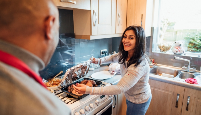 Woman serving food cooked on her range