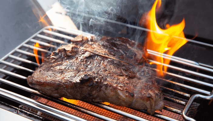 A Napoleon grill, grilling meat