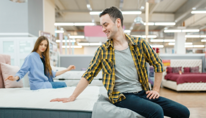 Couple trying out mattresses