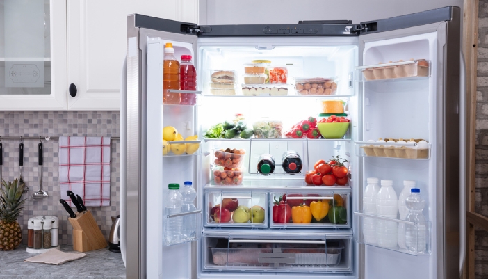 An open, well-organzied refrigerator that is clean