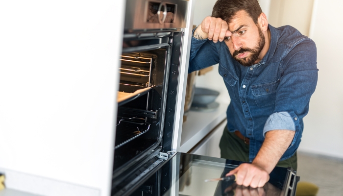 Man dealing with heat escaping his oven