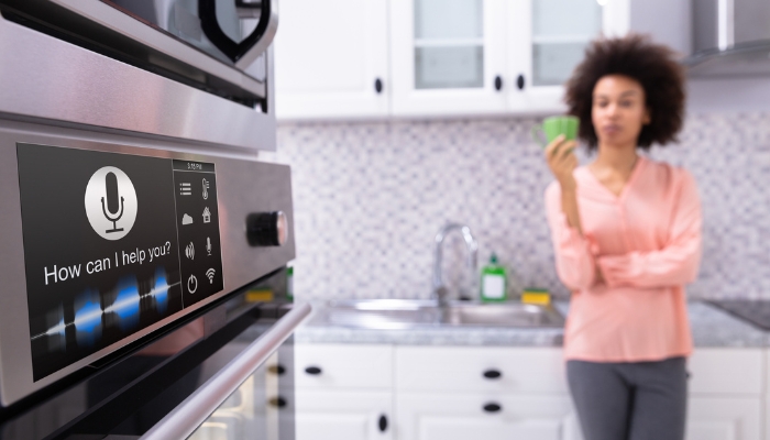 Woman using voice commands in smart kitchen