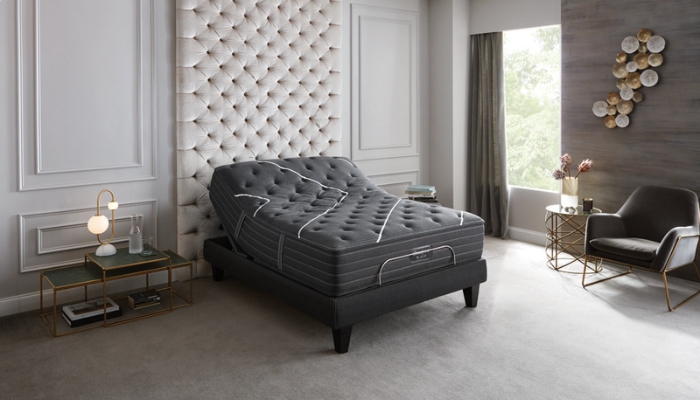 A black mattress lies in a luxurious bedroom