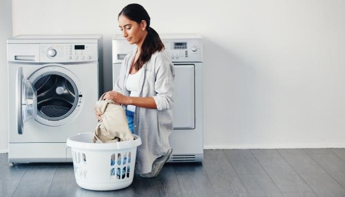 young woman doing laundry at home