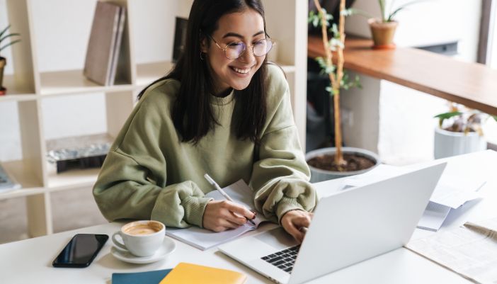 A young woman does research on her computer.