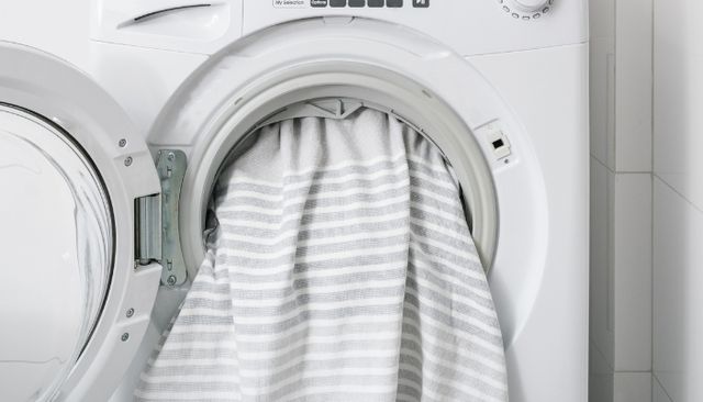 front view of dry sheets being pulled out of a dryer