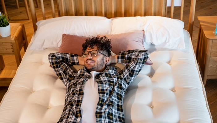man testing out new mattress in store