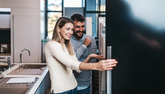 couple shopping for new refrigerator