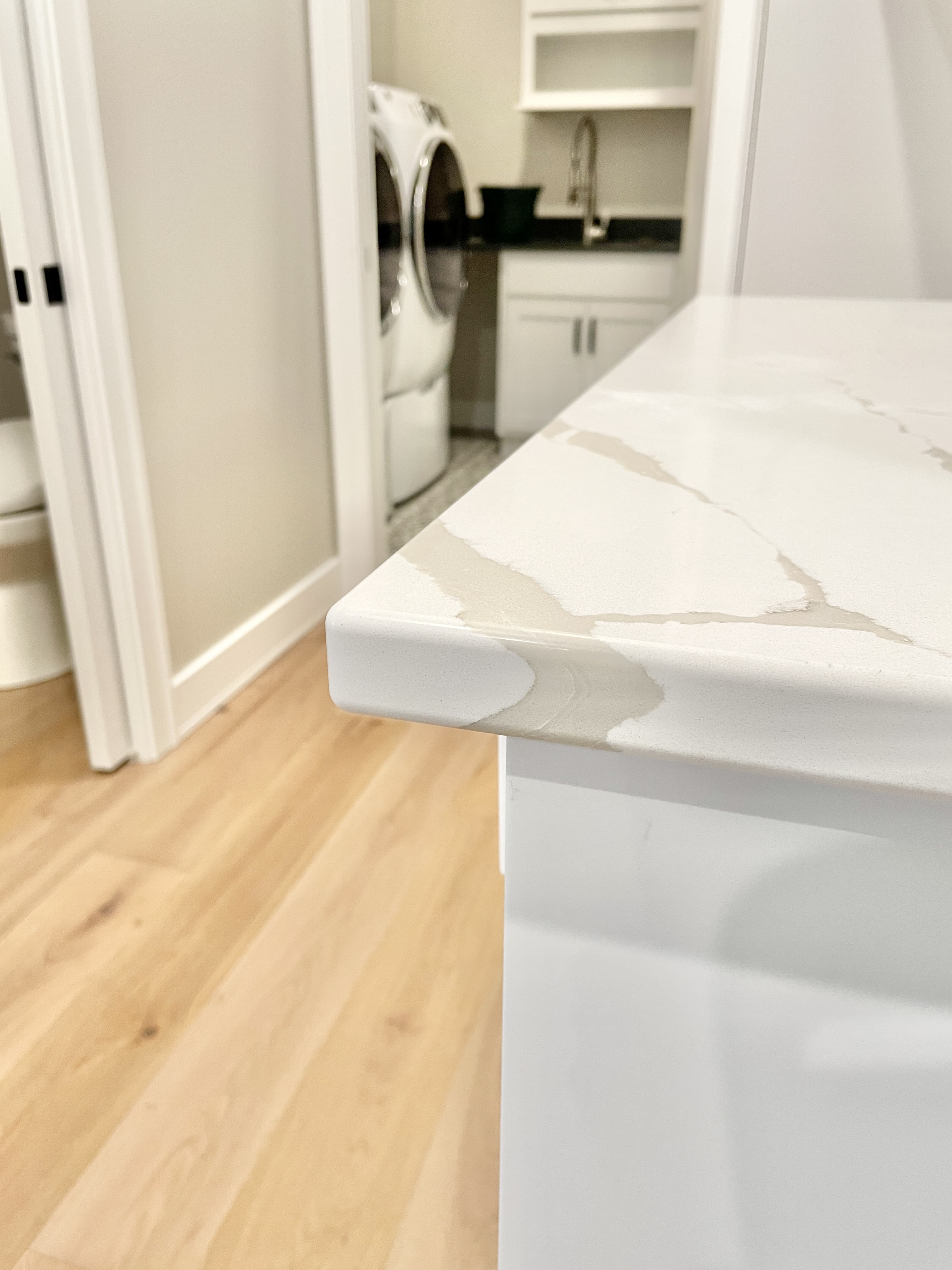 corner of calacatta laza quartz countertop on landing area 