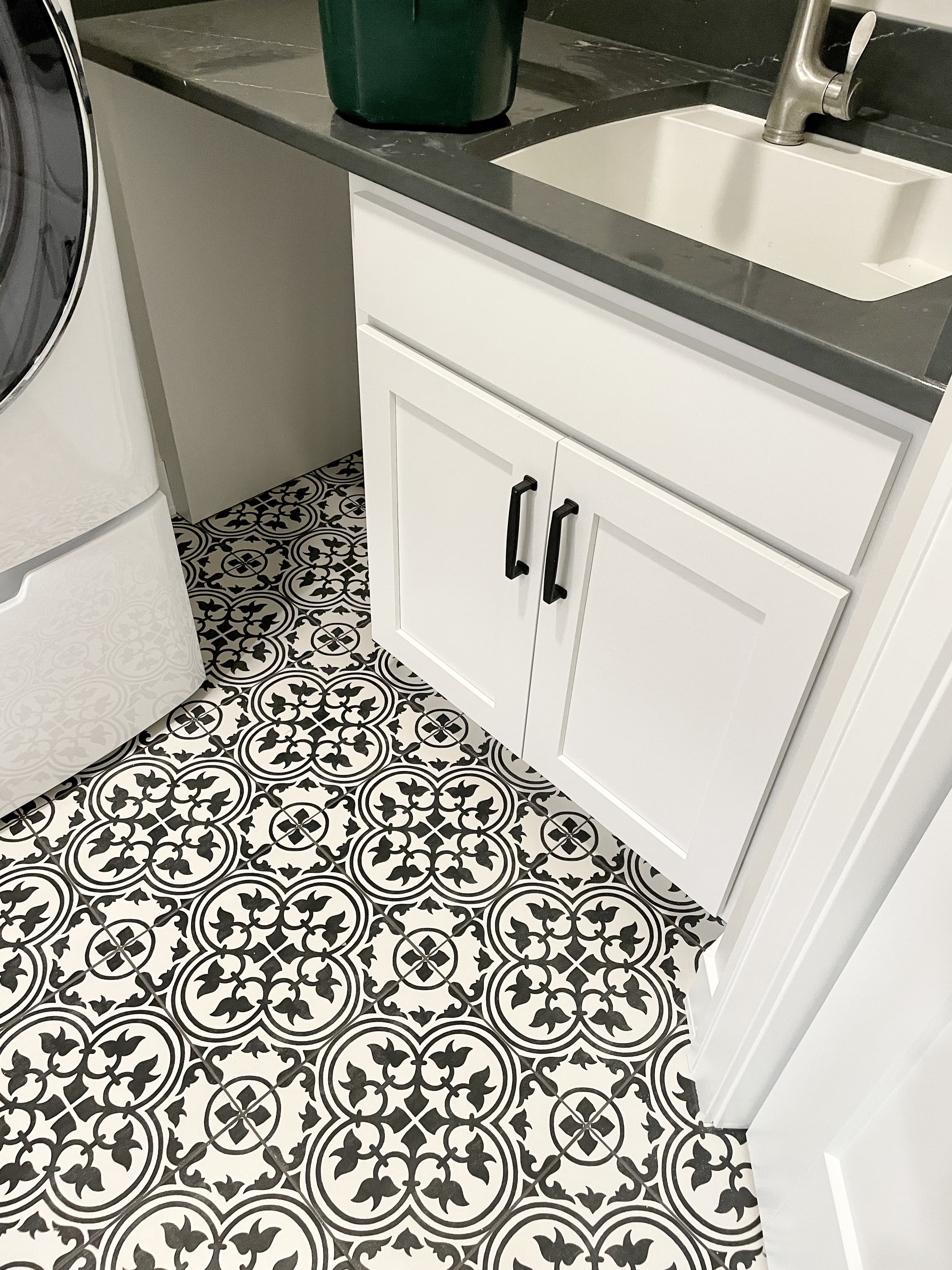 laundry room with black and white farmhouse patterned tile