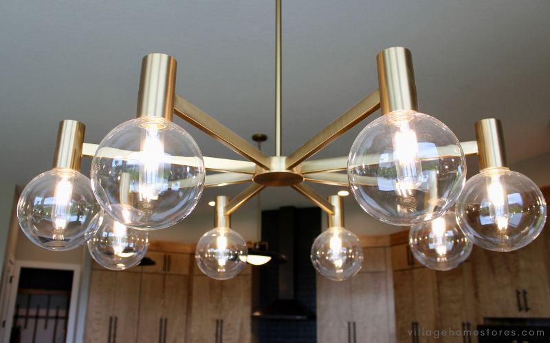 warm brass and clear glass midcentury chandelier in kitchen dinette area