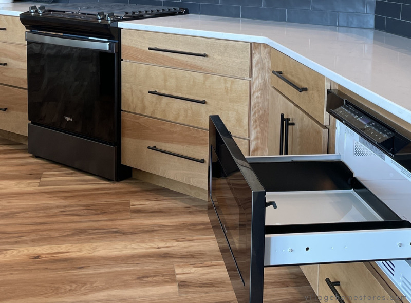 kitchen with black stainless appliances and sharp microwave drawer in the foreground