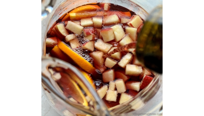 Close up of Christmas sangria being poured into a glass