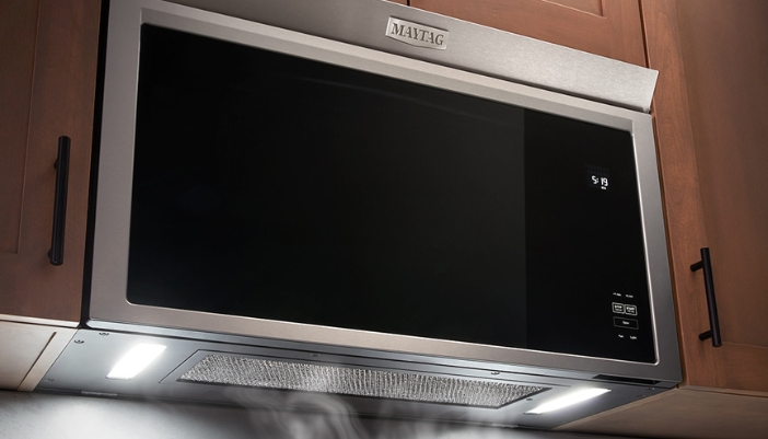 maytag flush microwave hood installed with vent open and steam being drawn up