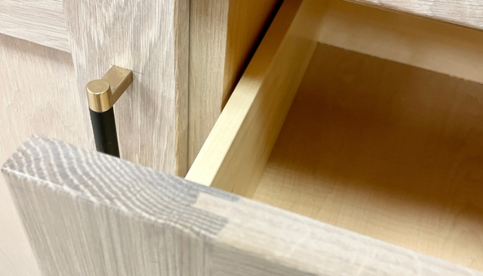 closeup shot of frameless cabinet with drawer width as close as possible to cabinet end