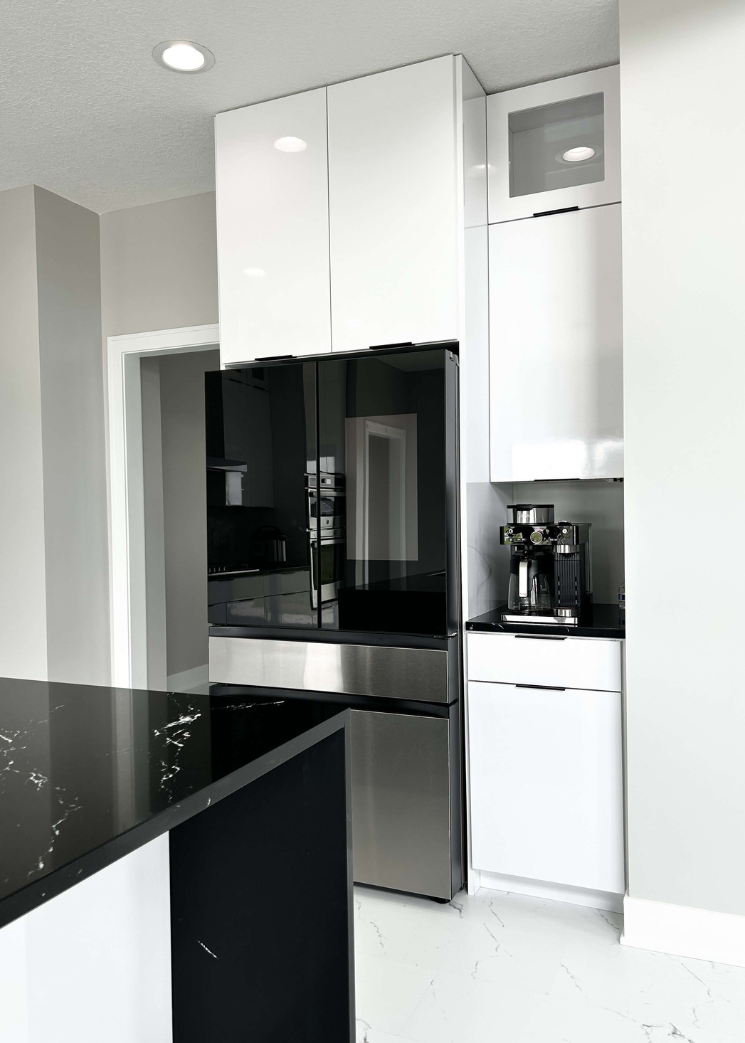 glossy white slab style laminate kitchen cabinets with stainless appliances
