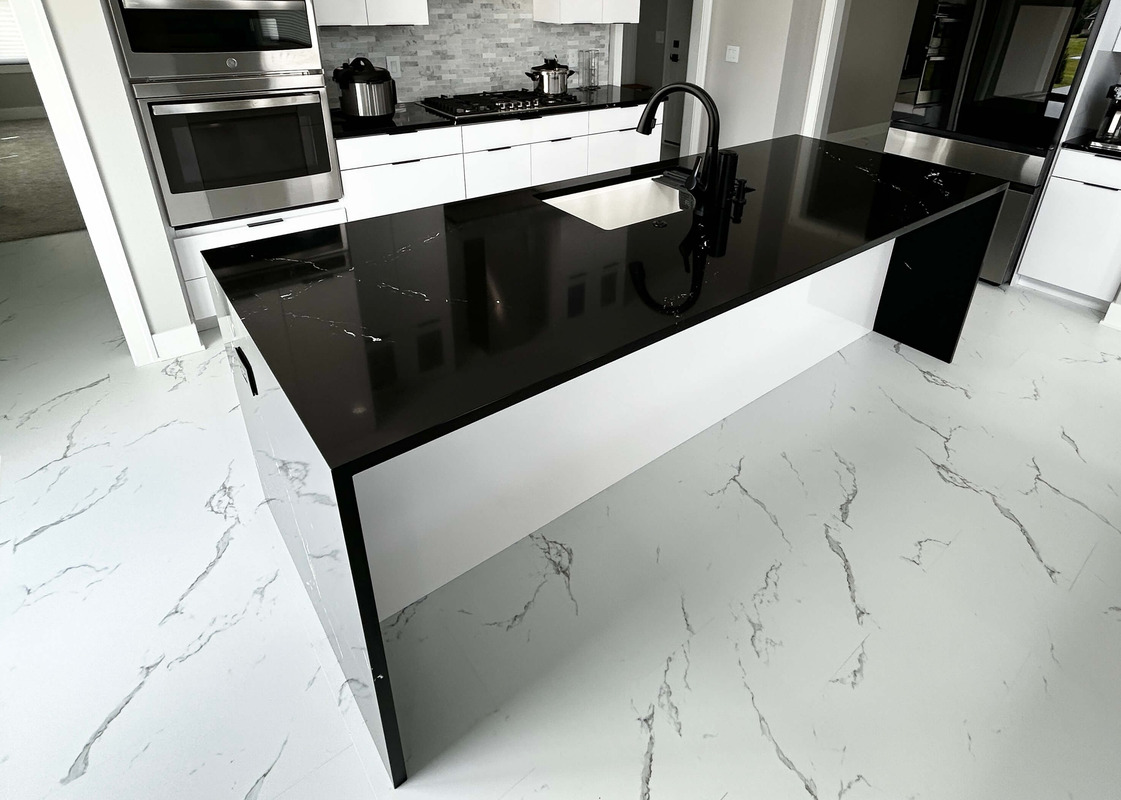 waterfalling black quartz island countertop. Cambria quartz for Village Home Stores